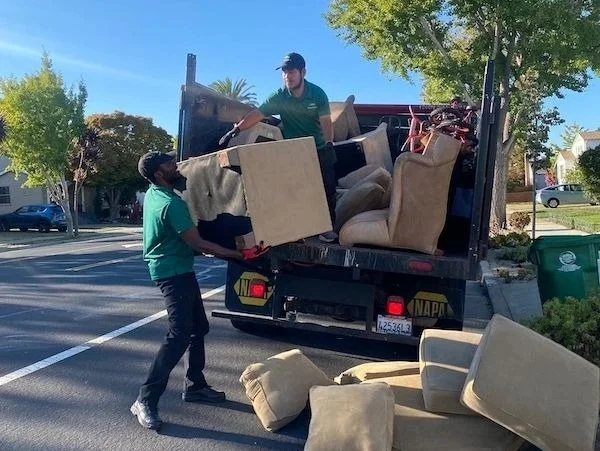 Men loading furniture onto truck - Alliance Junk Removal