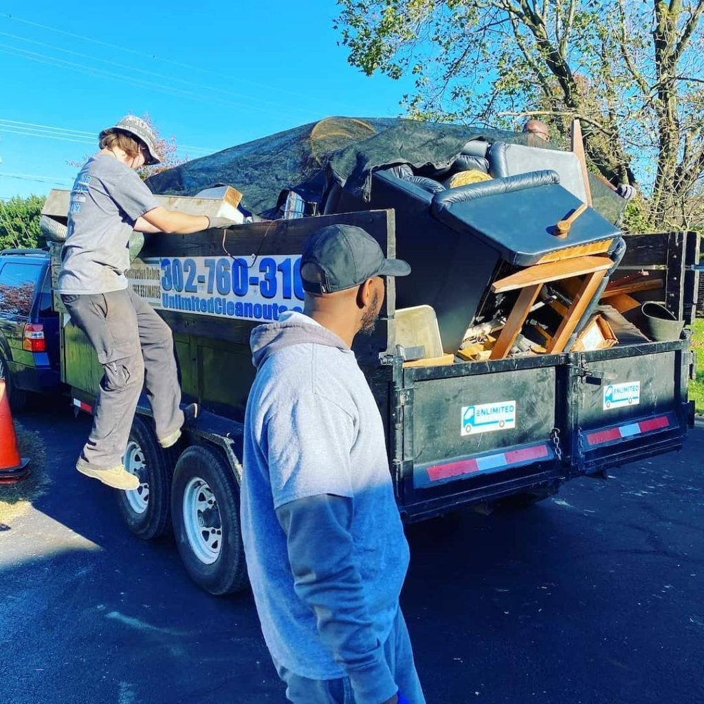 Men loading junk into a trailer - Alliance Junk Removal